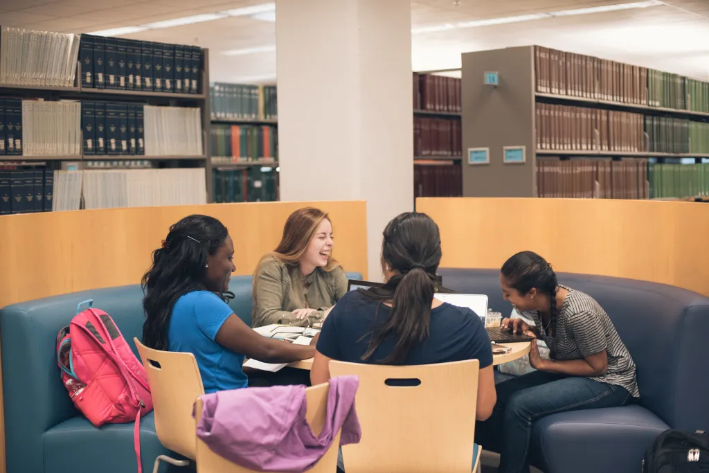 students working together in the library on campus